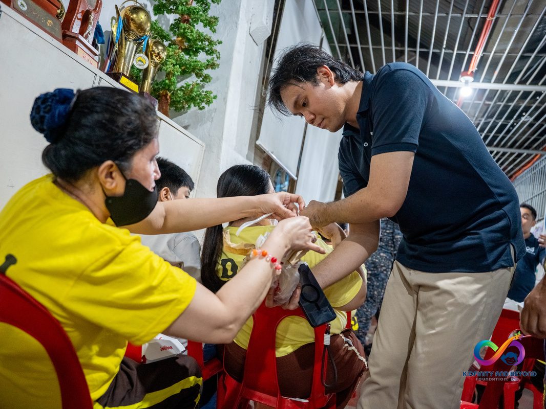 Staff member helping a mother and child at a briefing