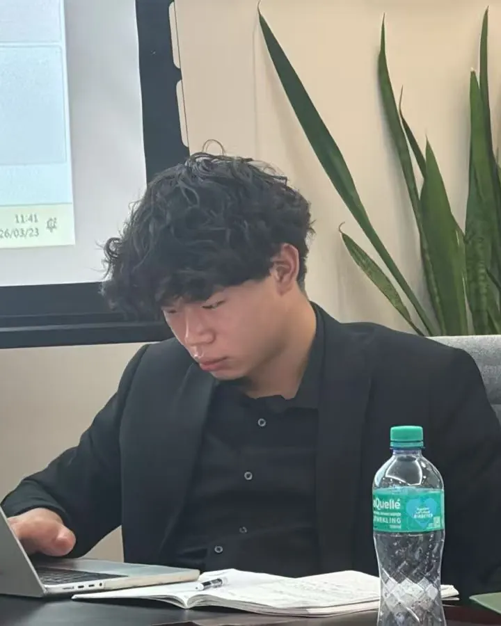 Yibo Yang working on a laptop at a desk